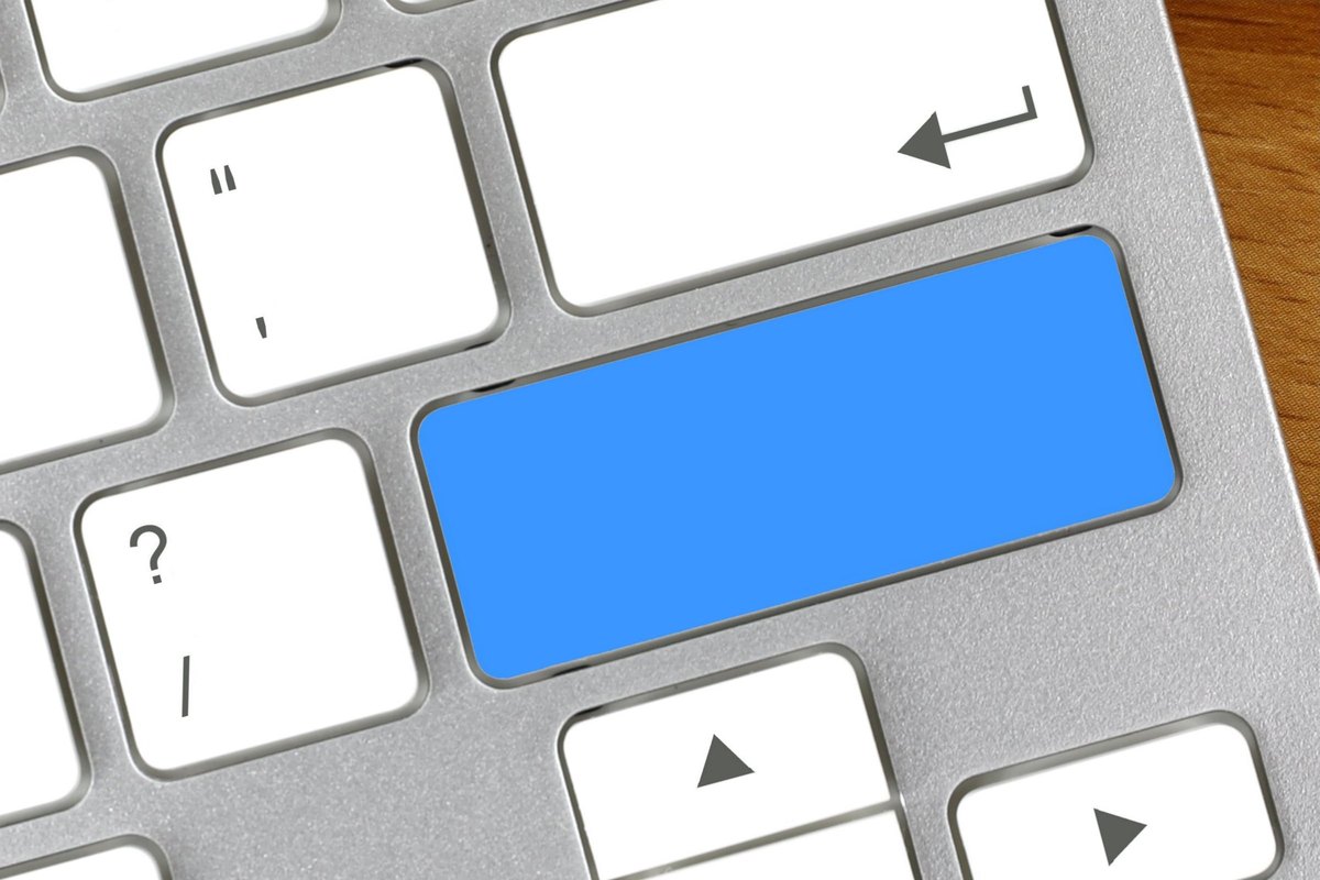Computer keyboard with a blank blue key - blank template