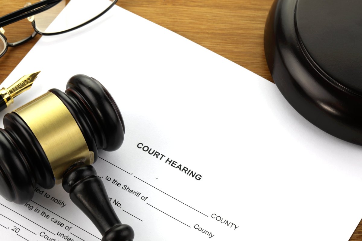 Court hearing document with gavel and fountain pen - blank template
