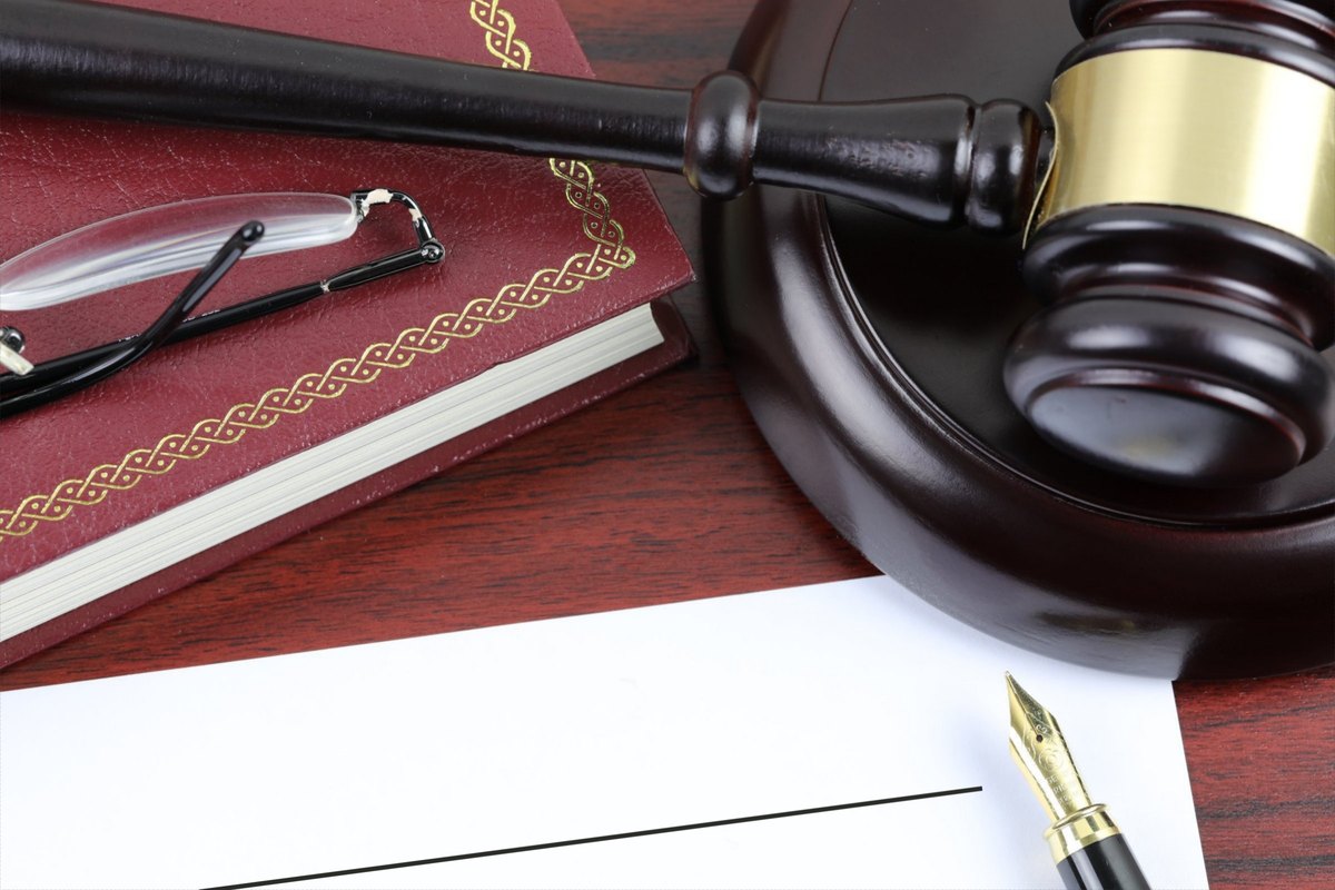 Blank paper with red book, gavel and fountain pen - blank template