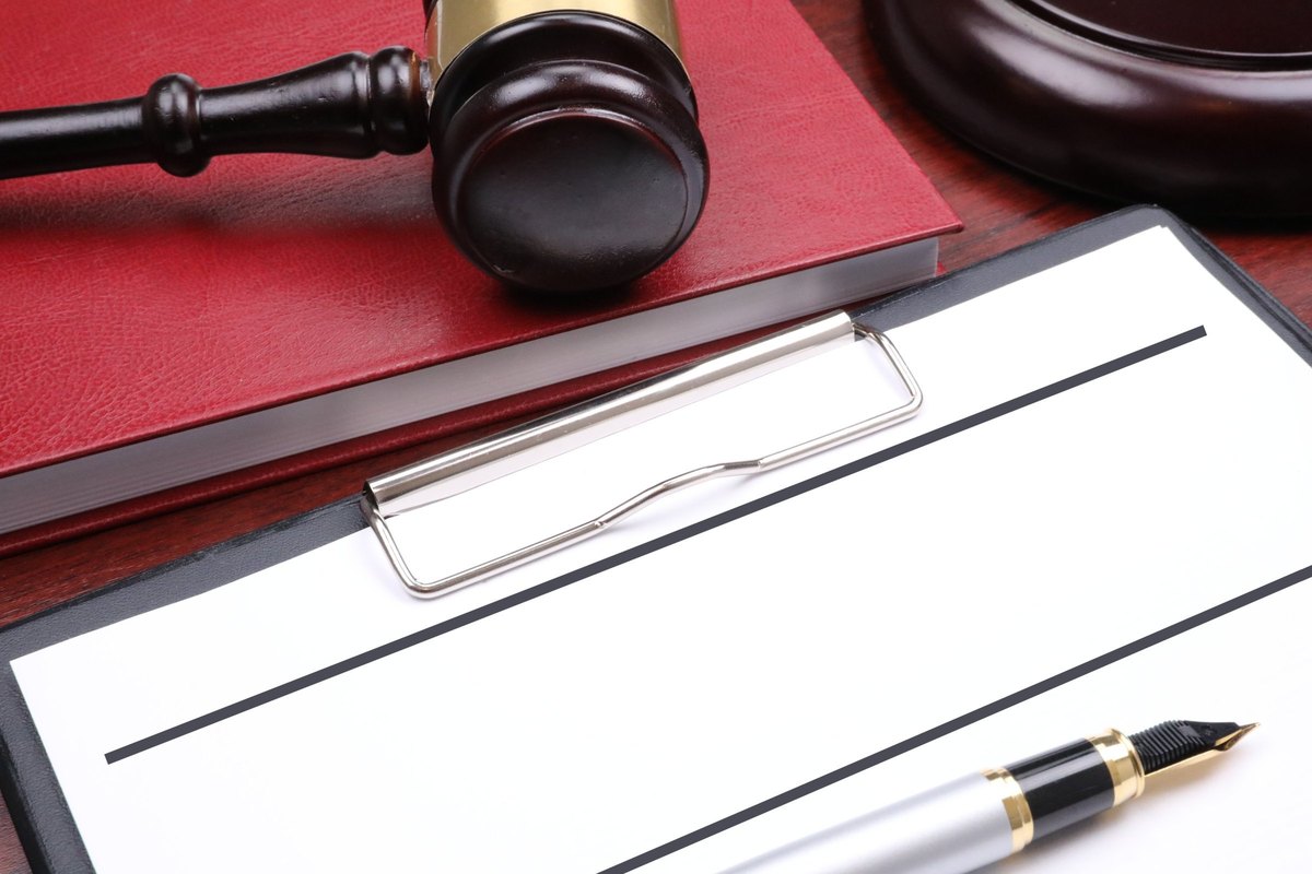 Clipboard with red book, gavel and fountain pen - blank template