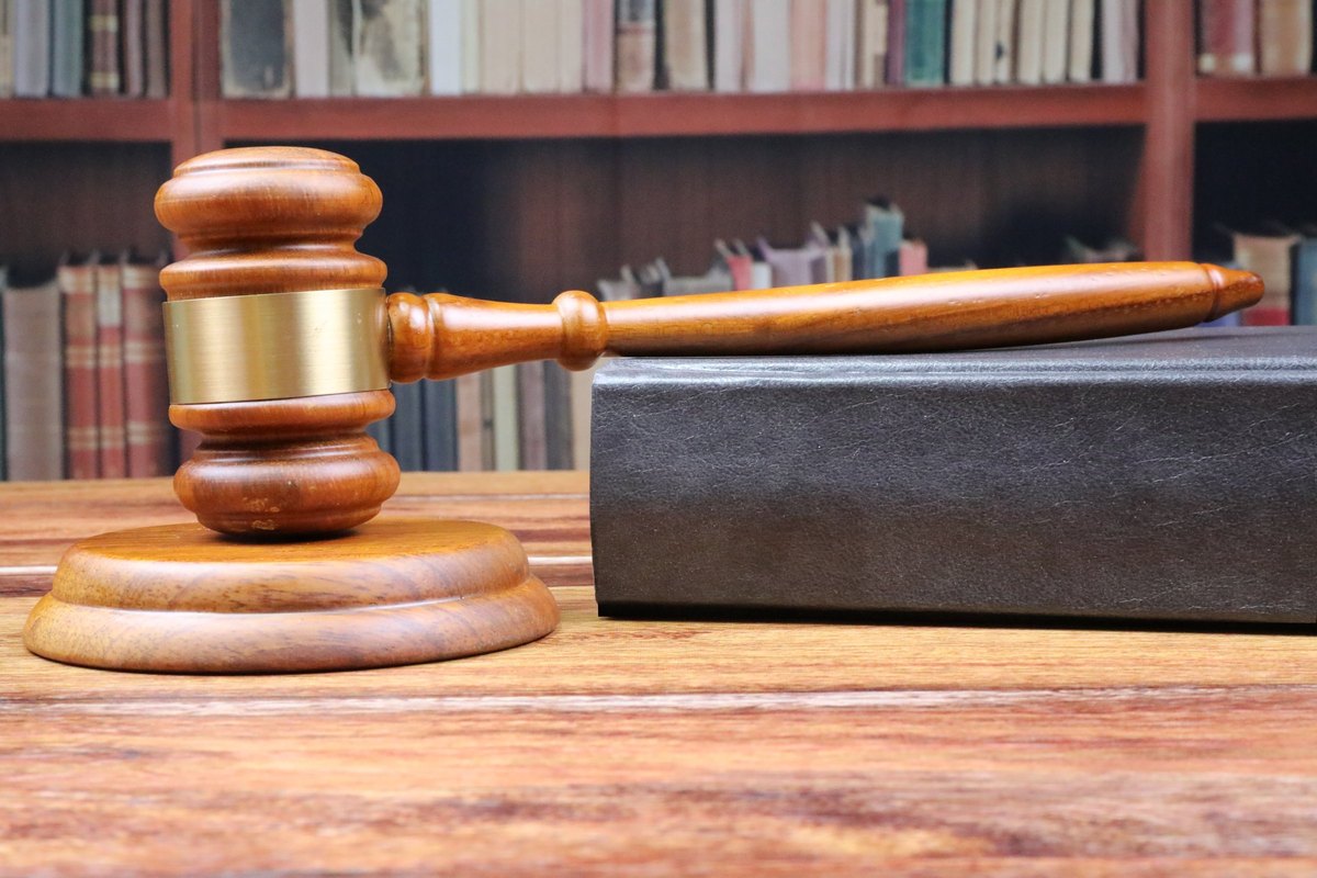 Gavel and sound block with a black law book - blank template