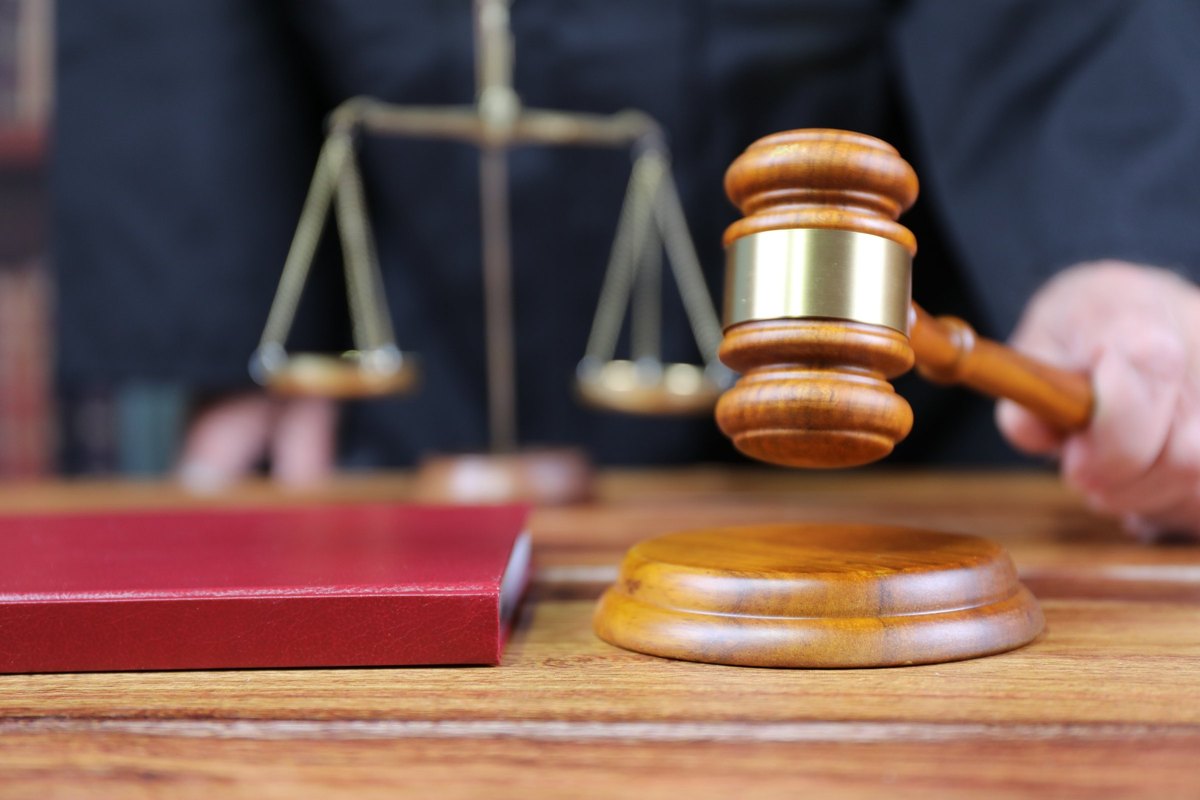Gavel and scales of justice with a red book - blank template