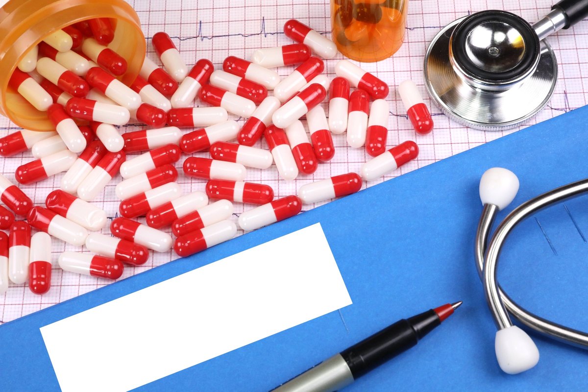 Red capsules on a blue folder with a blank label - blank template