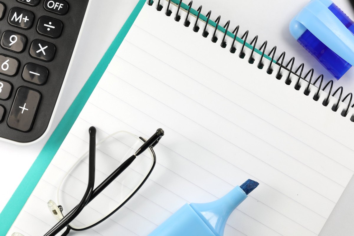 Lined spiral notepad with glasses and highlighter - blank template