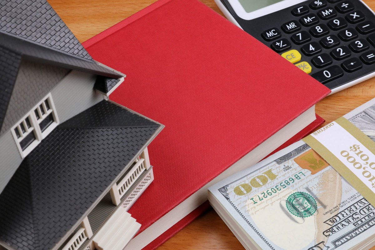 Red book with a model house and dollars - blank template