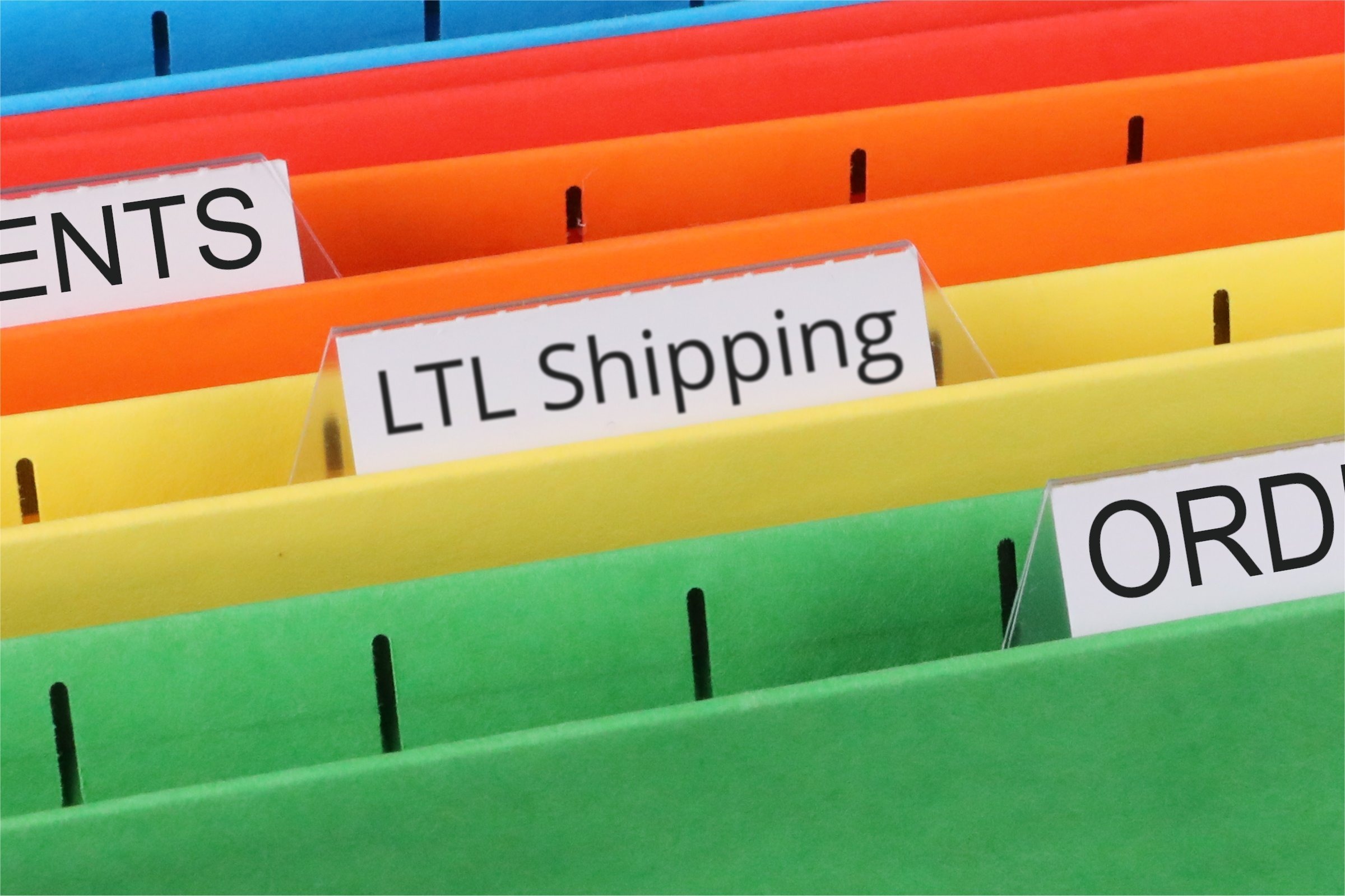 Colourful files with a blank tab template with the words "LTL Shipping" printed on the surface