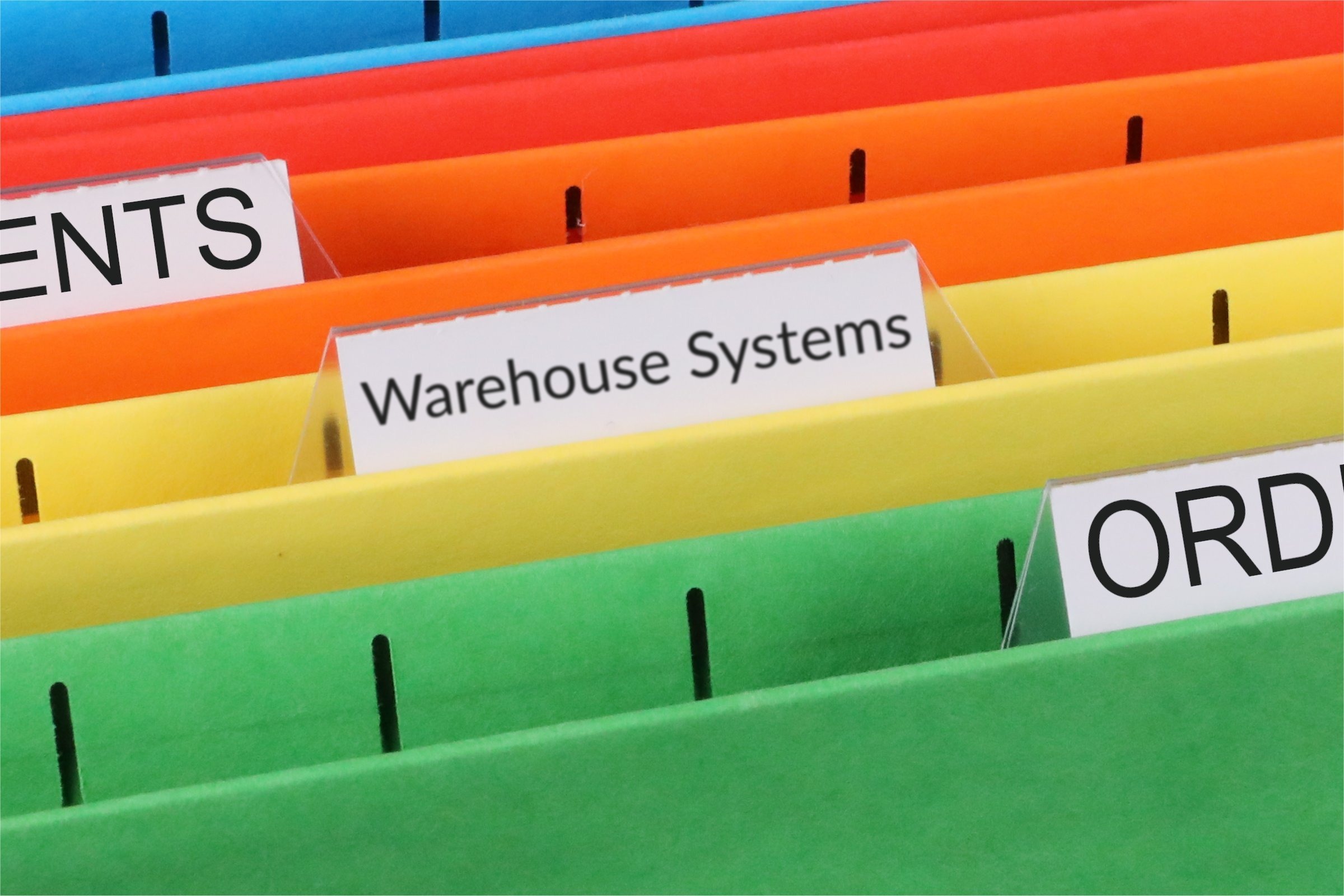 Colourful files with a blank tab template with the words "Warehouse Systems" printed on the surface
