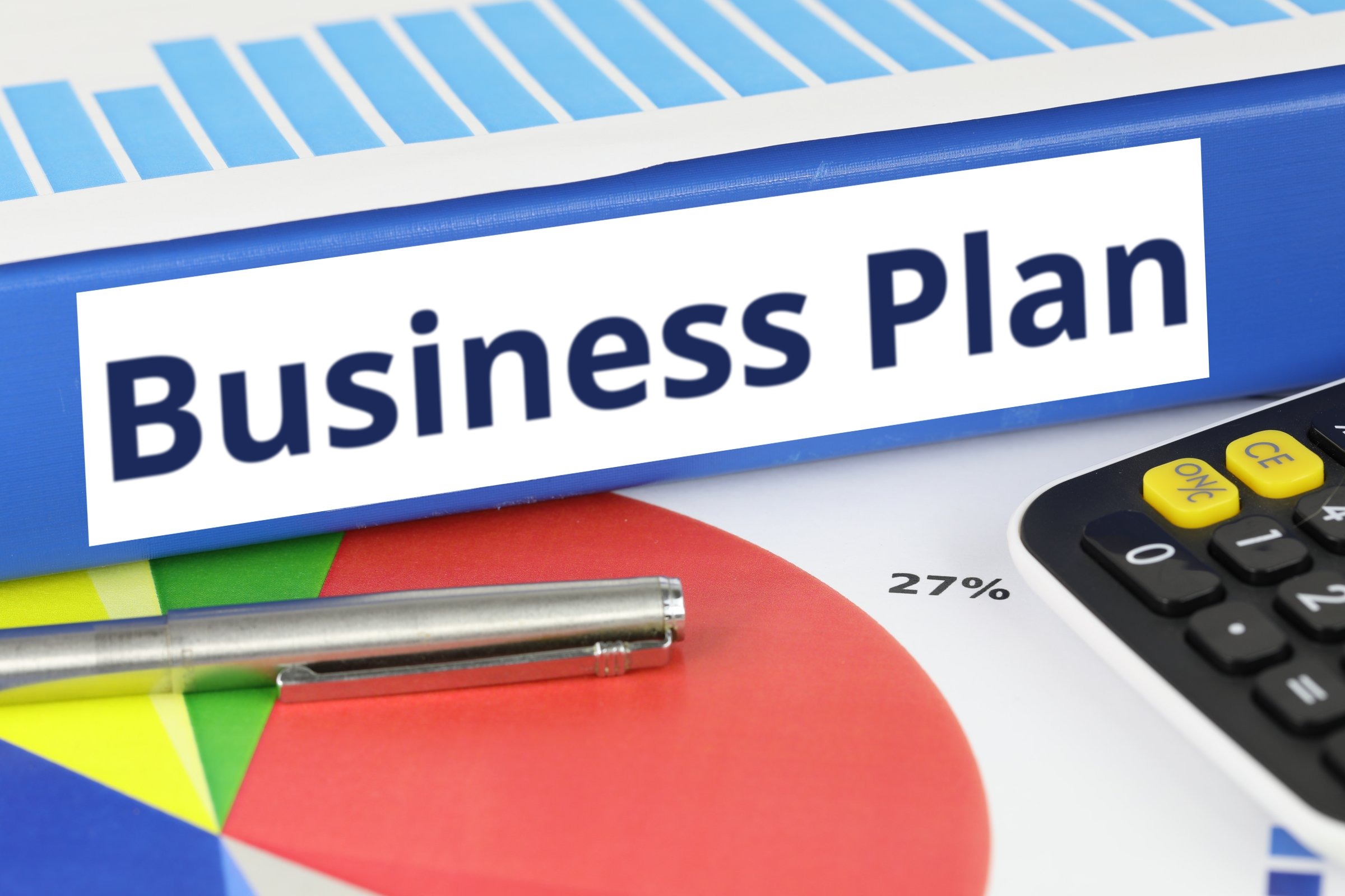 Blue ring binder with a blank label template with the words "Business Plan" printed on the surface