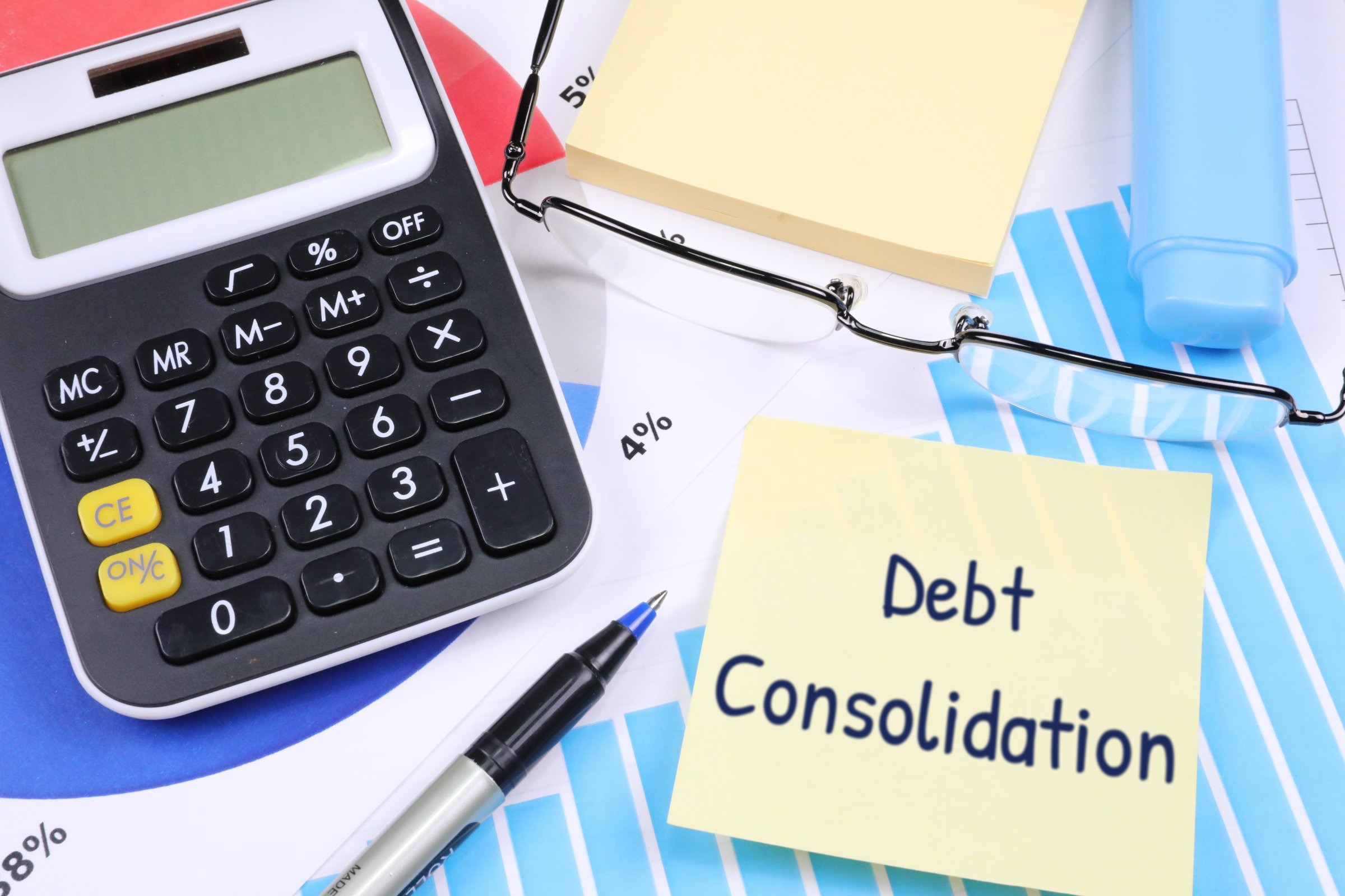 Sticky notes with calculator, glasses and pen template with the words "Debt Consolidation" printed on the surface