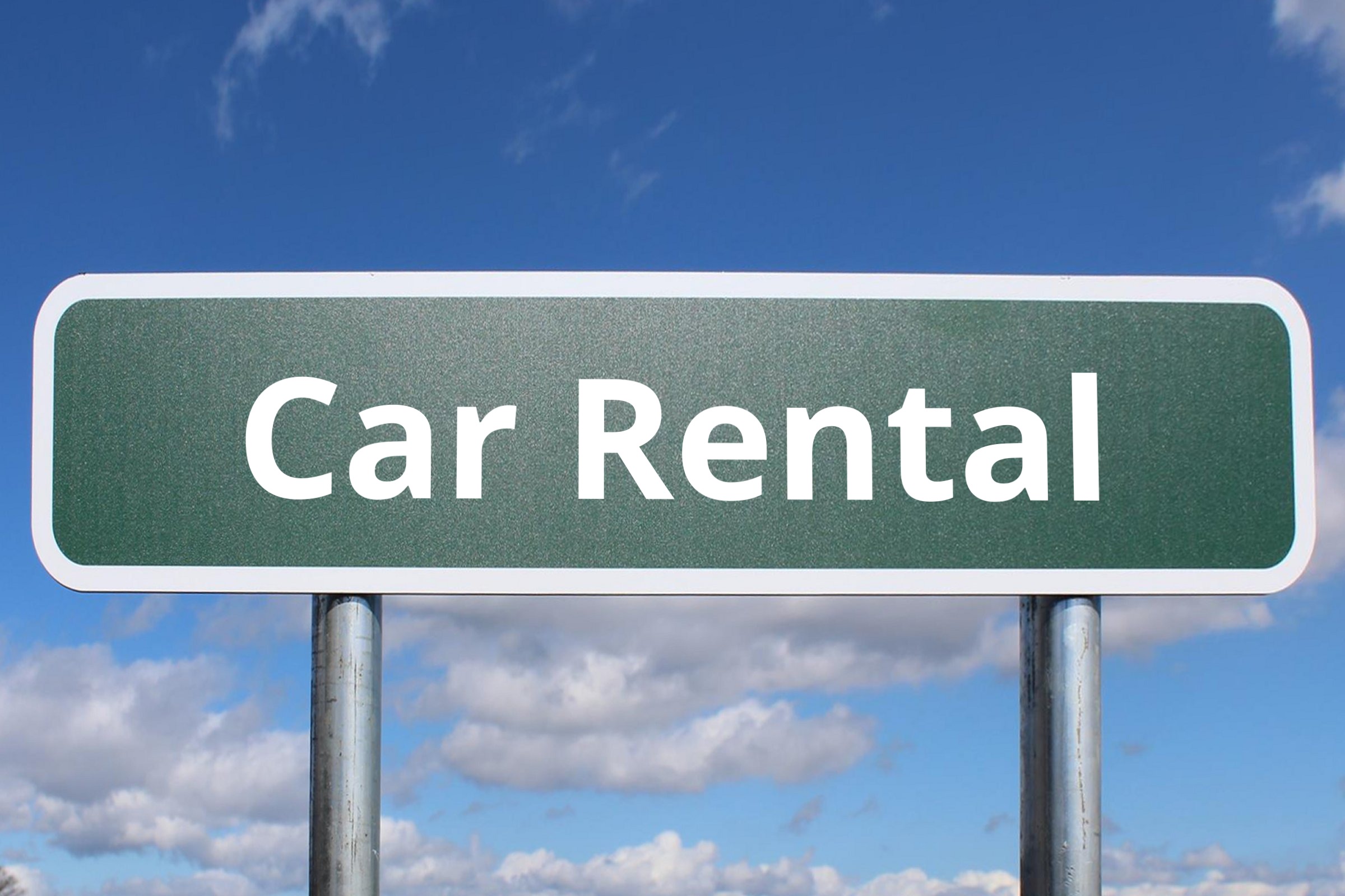 Blank green road sign against a blue sky template with the words "Car Rental" in plain lettering