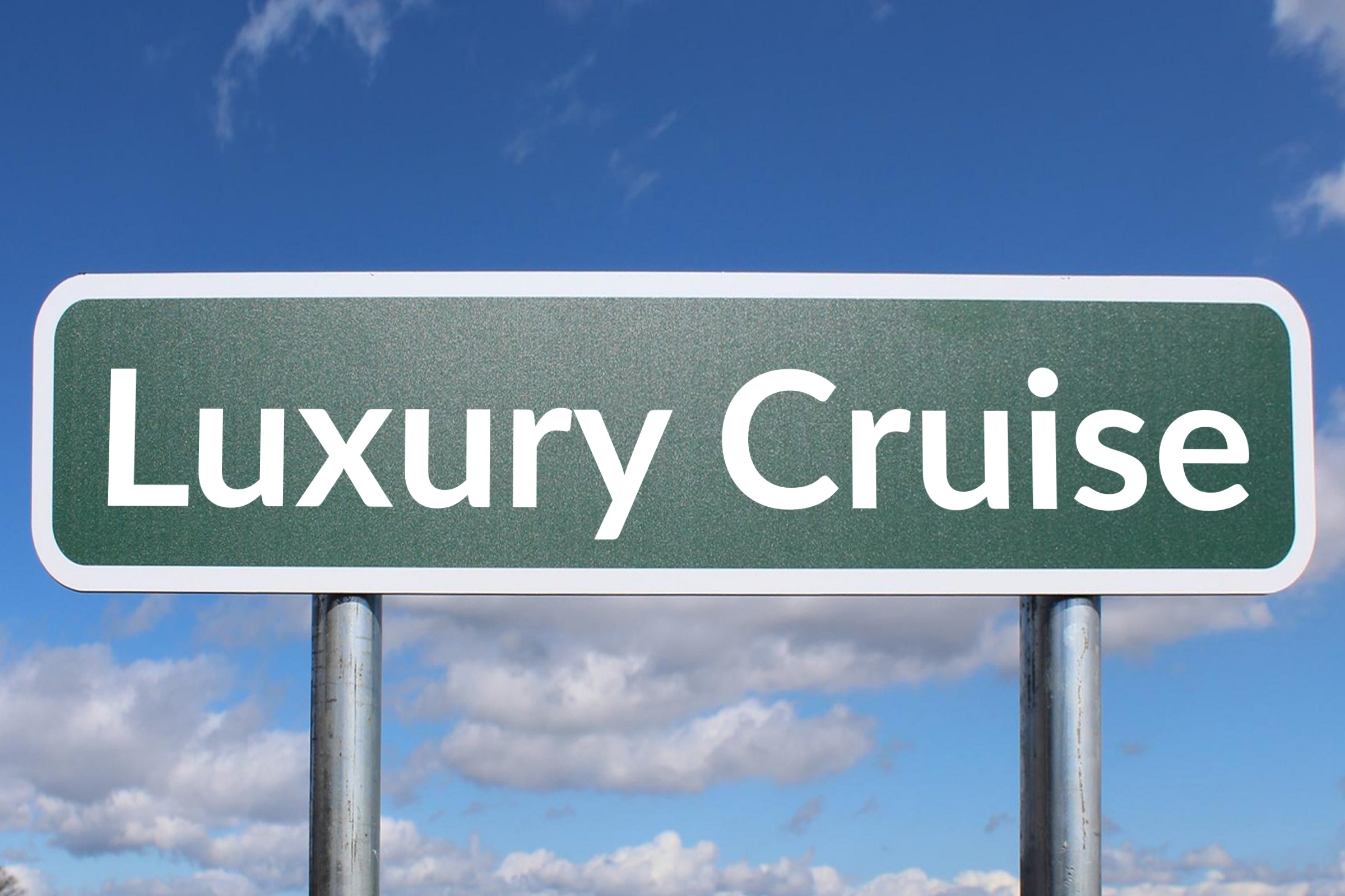 Blank green road sign against a blue sky template with the words "Luxury Cruise" in plain lettering