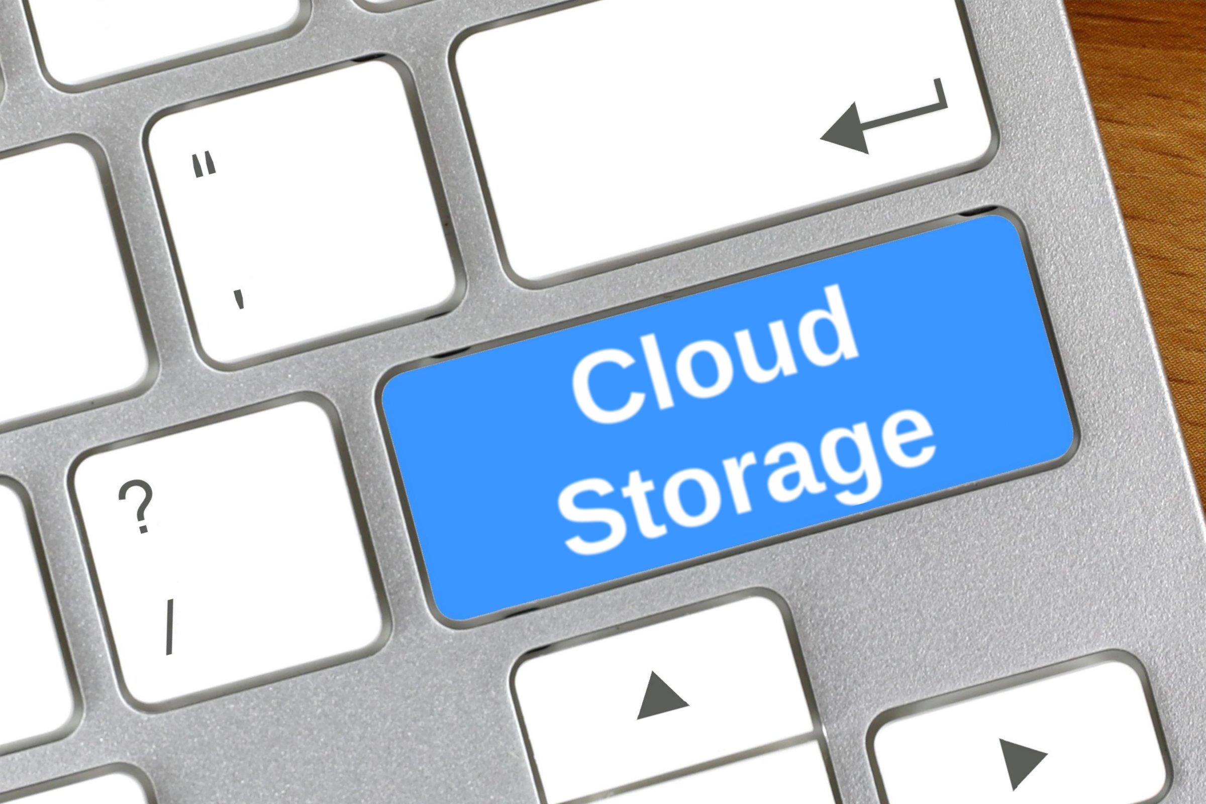 Computer keyboard with a blank blue key template with the words "Cloud Storage" printed on the surface