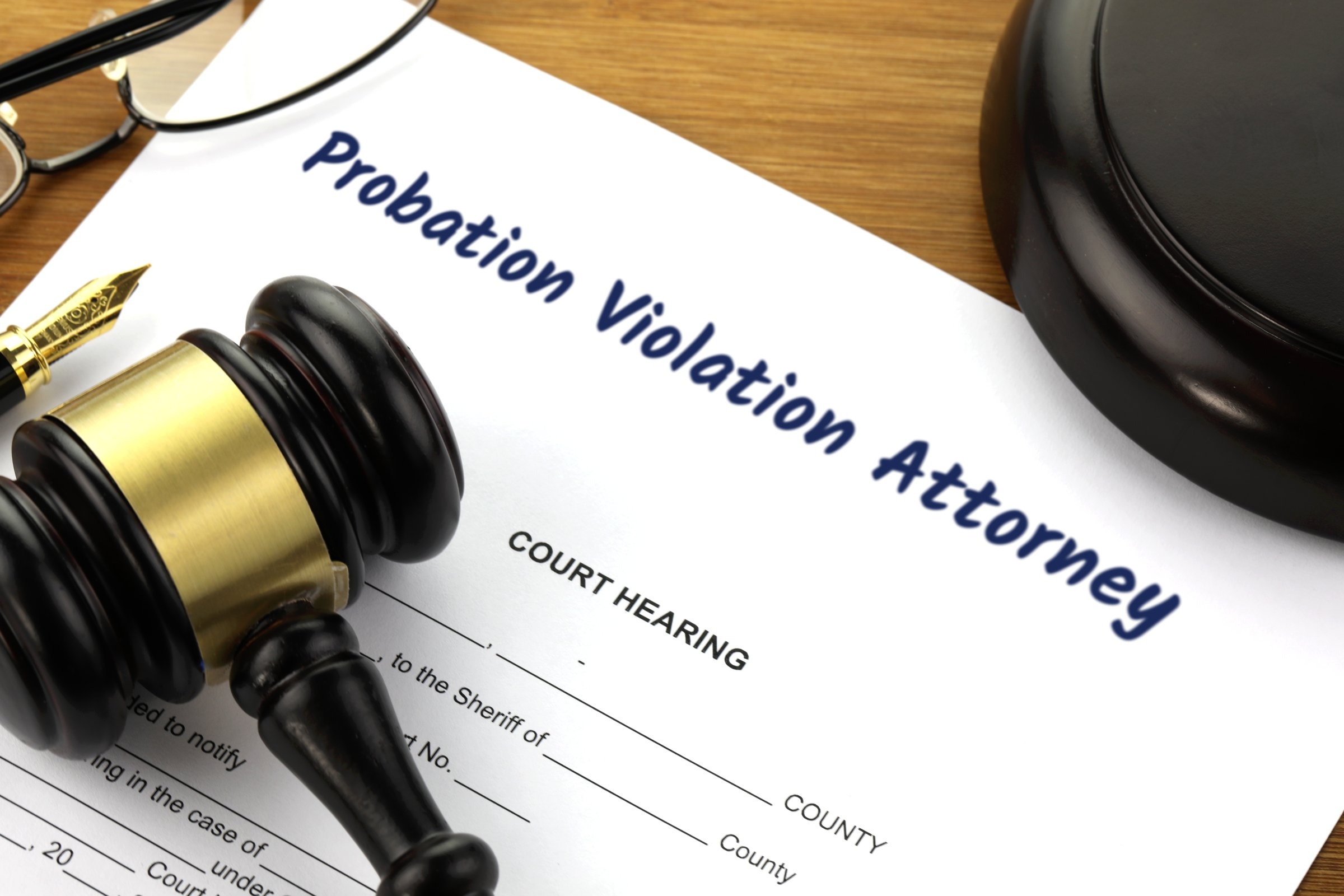 Court hearing document with gavel and fountain pen template with the words "Probation Violation Attorney" printed on the surface