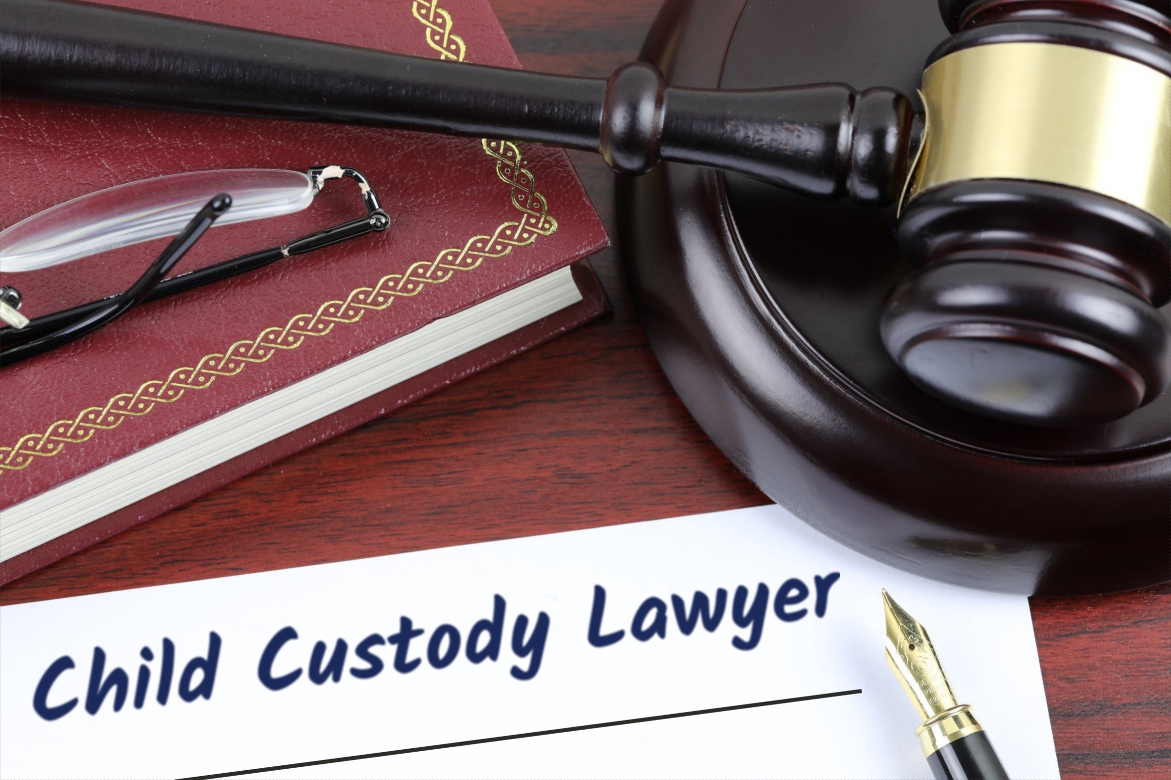 Blank paper with red book, gavel and fountain pen template with the words "Child Custody Lawyer" printed on the surface
