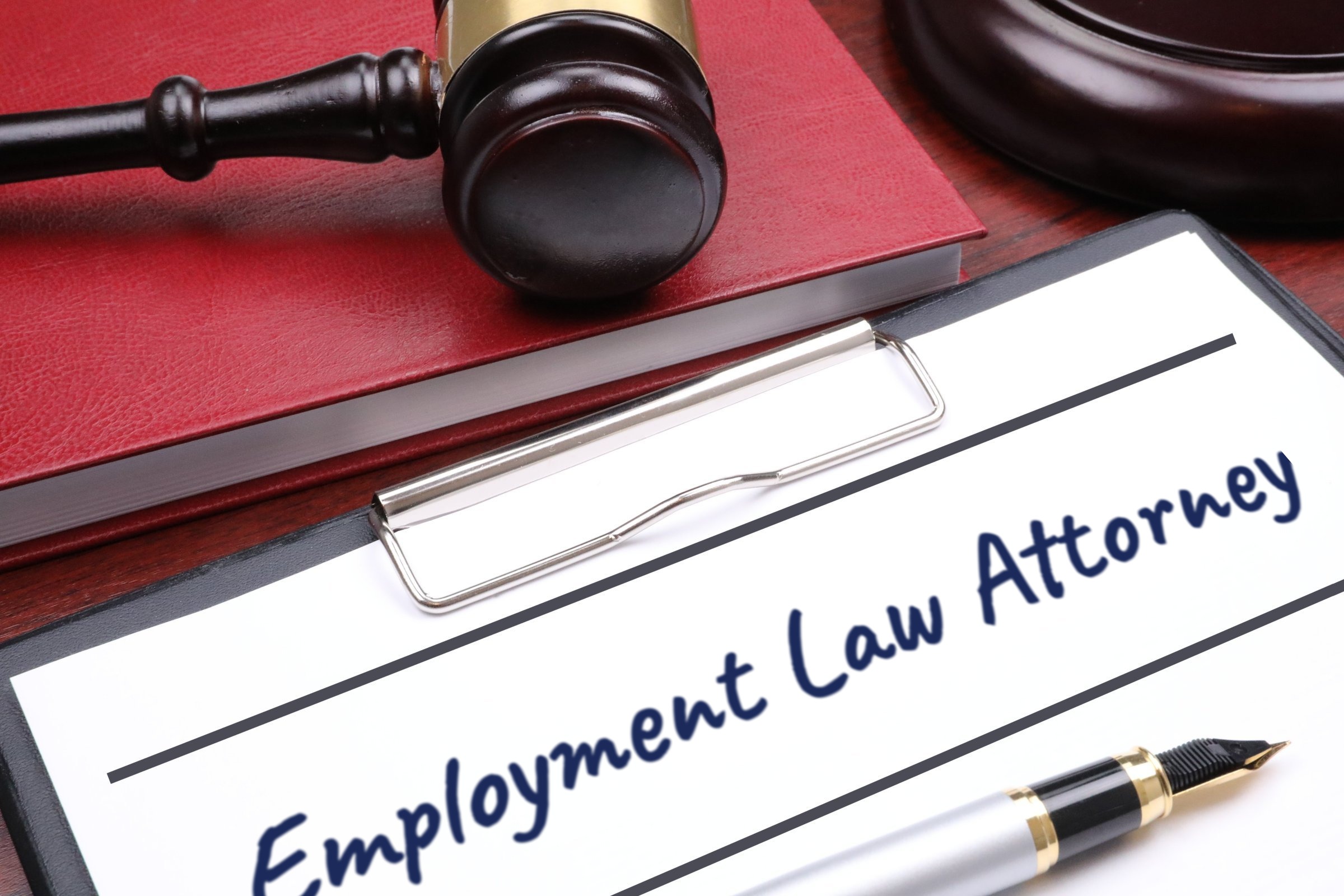 Clipboard with red book, gavel and fountain pen template with the words "Employment Law Attorney" printed on the surface