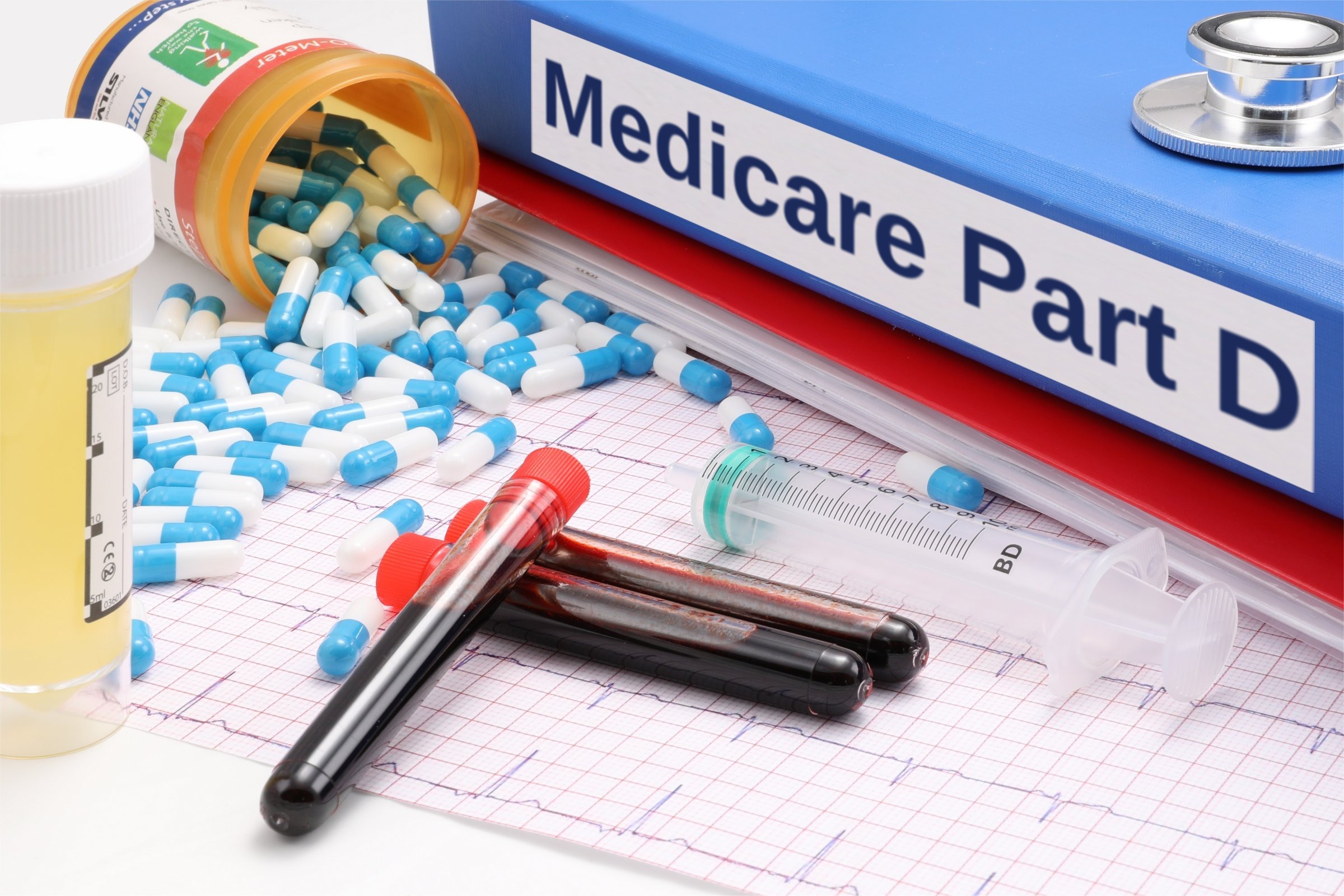 Blue binder with capsules, test tubes and syringe template with the words "Medicare Part D" printed on the surface