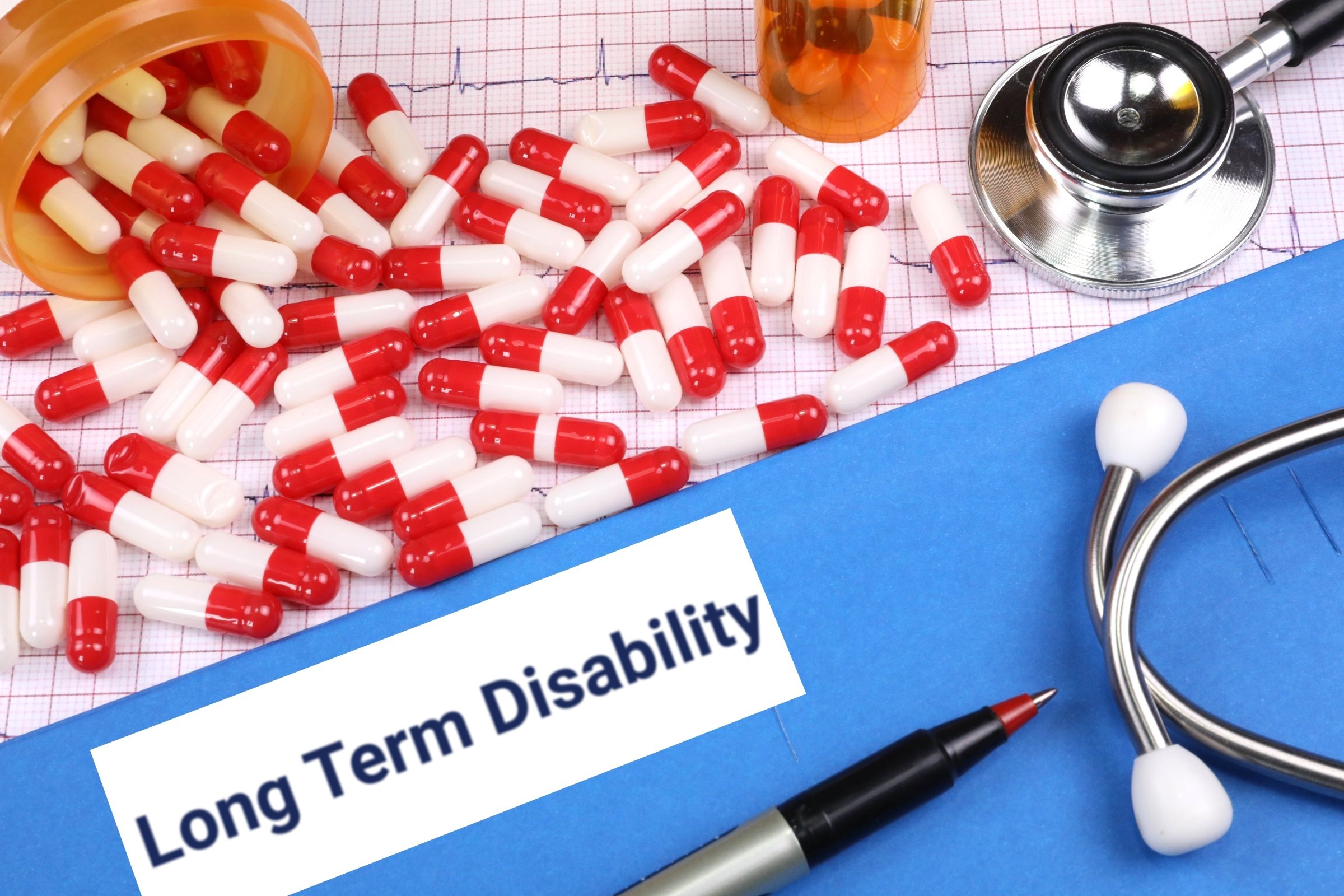 Red capsules on a blue folder with a blank label template with the words "Long Term Disability" printed on the surface