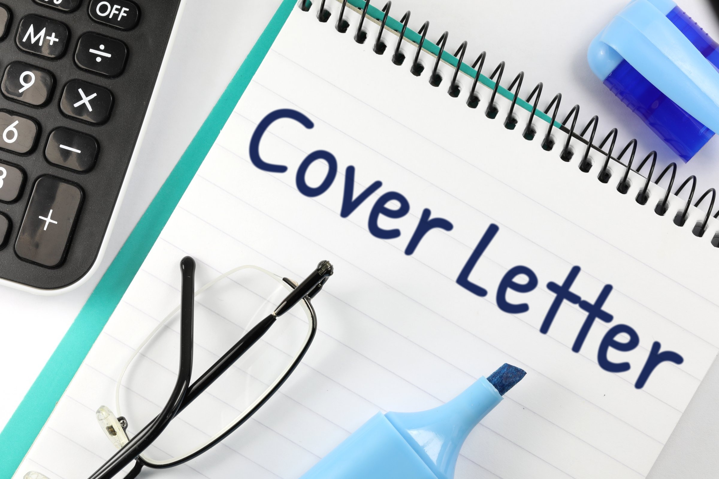 Lined spiral notepad with glasses and highlighter template with the words "Cover Letter" printed on the surface