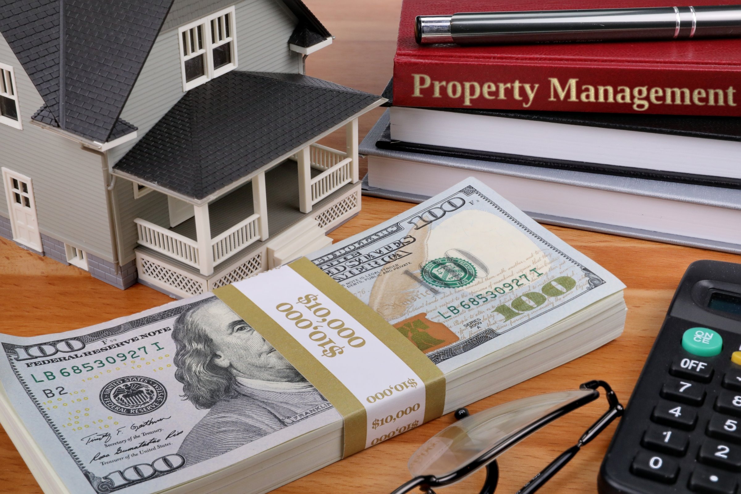 Model house with books and dollars template with the words "Property Management" in metallic foil lettering