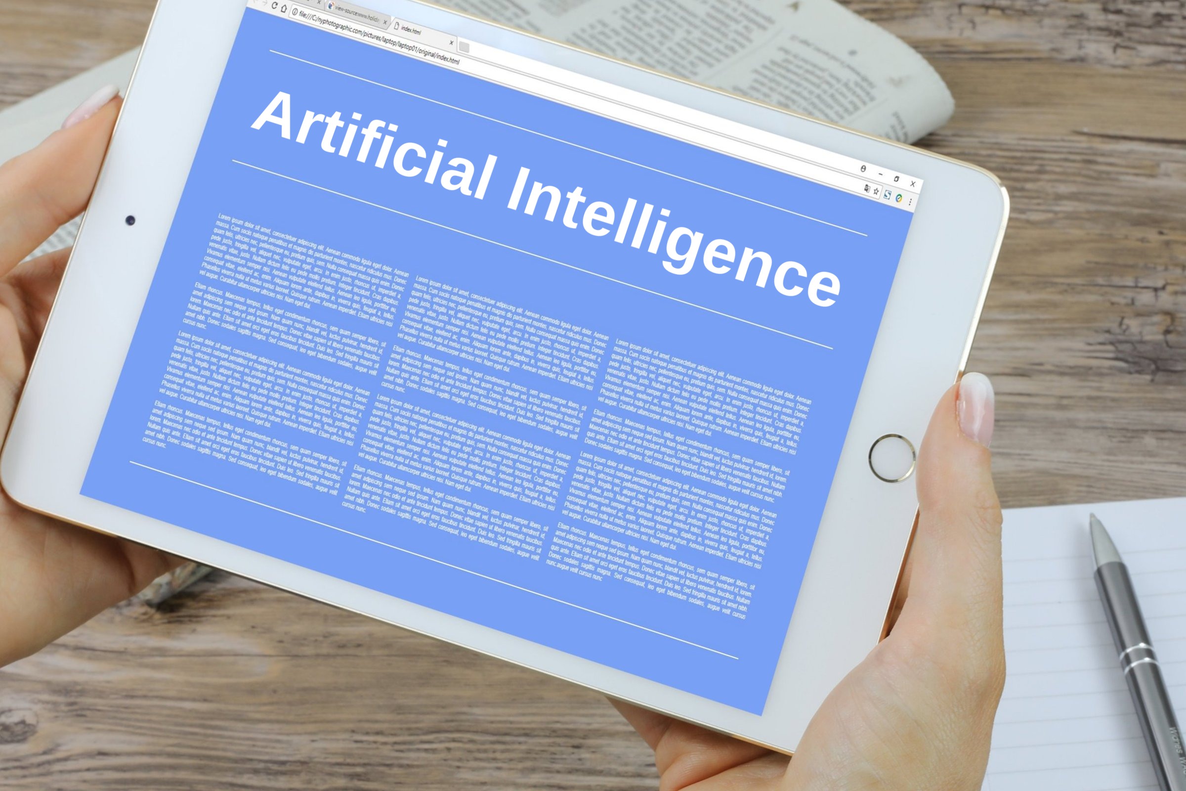Hand holding a tablet with a blank blue screen template with the words "Artificial Intelligence" in plain lettering